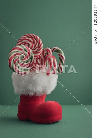 Christmas candy canes and  lollipops in Santa Claus boot 120692147