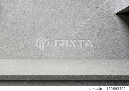Grey Stucco Table and Wall with Natural Light and and Minimal Beam on Right, Suitable for Product Presentation Backdrop, Display, and Mock up. 120692362
