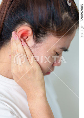 Woman holding her painful Ear. Ear disease, Atresia, Otitis Media, Inflation, Pertorated Eardrum, Meniere syndrome, otolaryngologist, Ageing Hearing Loss and Health concept Woman holding her painful Ear. Ear disease, Atresia, Otitis Media, Inflation, Pertorated Eardrum, Meniere syndrome, otolaryngologist, Ageing Hearing Loss and Health concept 120692603