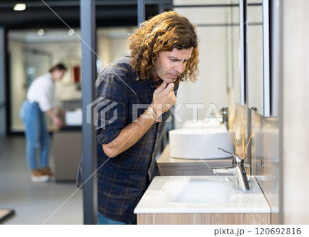 Confident male customer choosing bathroom sink in hardware store Confident male customer choosing bathroom sink in hardware store 120692816