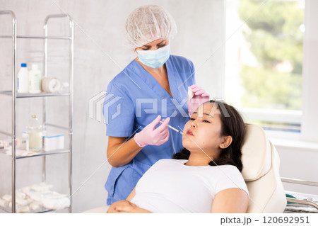 Woman getting facial beauty treatment Woman getting facial beauty treatment 120692951
