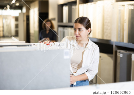 woman is considering MDF boards for internal insulation of residential premises 120692960