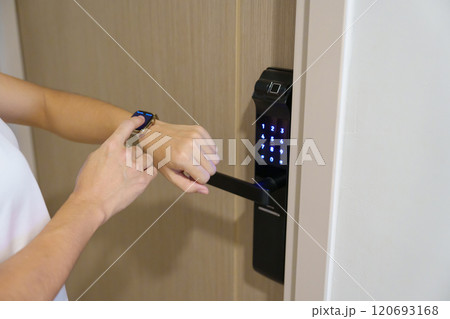 Hand using smartwatch for open digital door lock at home or apartment. NFC Technology, Fingerprint scan, keycard, PIN number, smartphone, electrical and contactless lifestyle concepts Hand using smartwatch for open digital door lock at home or apartment. NFC Technology, Fingerprint scan, keycard, PIN number, smartphone, electrical and contactless lifestyle concepts 120693168