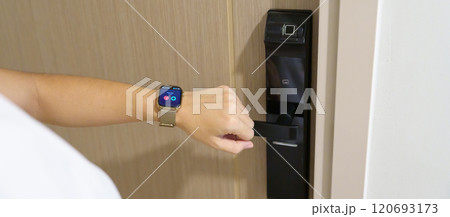 Hand using smartwatch for open digital door lock at home or apartment. NFC Technology, Fingerprint scan, keycard, PIN number, smartphone, electrical and contactless lifestyle concepts Hand using smartwatch for open digital door lock at home or apartment. NFC Technology, Fingerprint scan, keycard, PIN number, smartphone, electrical and contactless lifestyle concepts 120693173