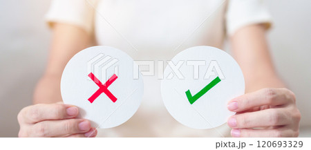 Woman show Wrong and Right symbol paper. True and false, accept and rejected, evaluation, Vote, Poll, Yes or No and Survey concepts Woman show Wrong and Right symbol paper. True and false, accept and rejected, evaluation, Vote, Poll, Yes or No and Survey concepts 120693329