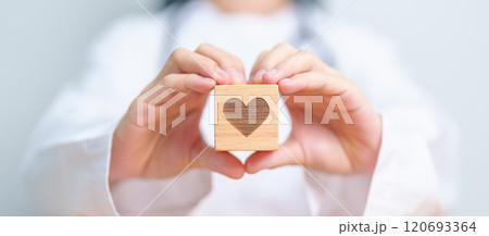 Doctor hand holding heart shape block in hospital. love, donor, world heart day, world health day, CSR donation and Insurance concepts Doctor hand holding heart shape block in hospital. love, donor, world heart day, world health day, CSR donation and Insurance concepts 120693364