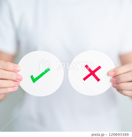 Woman show Wrong and Right symbol paper. True and false, accept and rejected, evaluation, Vote, Poll, Yes or No and Survey concepts Woman show Wrong and Right symbol paper. True and false, accept and rejected, evaluation, Vote, Poll, Yes or No and Survey concepts 120693389