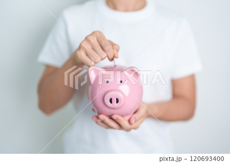 Money Saving for Future Plan, Retirement fund, Pension, Investment, Wealth Business and Financial concepts. hand holding and putting into piggy bank, Money Counting for World Savings day and Donate 120693400