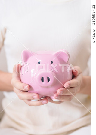 Money Saving for Future Plan, Retirement fund, Pension, Investment, Wealth Business and Financial concepts. hand holding and putting into piggy bank, Money Counting for World Savings day and Donate 120693412