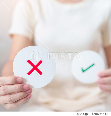 Woman show Wrong symbol paper. True and false, accept and rejected, evaluation, Vote, Poll, Yes or No and Survey concepts 120693418