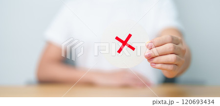 Woman show Wrong symbol paper. True and false, accept and rejected, evaluation, Vote, Poll, Yes or No and Survey concepts 120693434