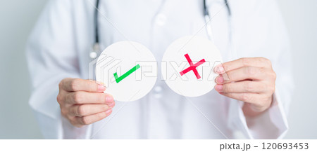 Doctor show Wrong symbol paper. True and false, accept and rejected, evaluation, Diagnosis, Vote, Poll, Yes or No, Health, Medical and Survey concepts 120693453
