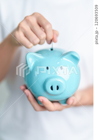 Money Saving for Future Plan, Retirement fund, Pension, Investment, Wealth Business and Financial concepts. hand holding and putting into piggy bank, Money Counting for World Savings day and Donate 120693509