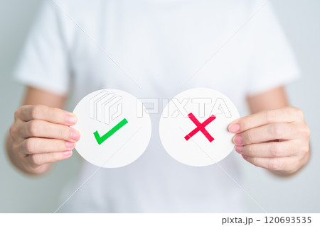 Woman show Wrong and Right symbol paper. True and false, accept and rejected, evaluation, Vote, Poll, Yes or No and Survey concepts 120693535