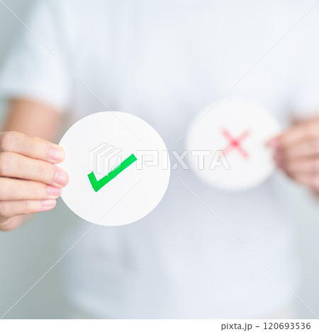 Woman show Right symbol paper. True and false, accept and rejected, evaluation, Vote, Poll, Yes or No and Survey concepts 120693536