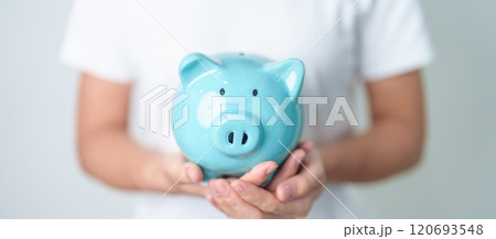 Money Saving for Future Plan, Retirement fund, Pension, Investment, Wealth Business and Financial concepts. hand holding and putting into piggy bank, Money Counting for World Savings day and Donate Money Saving for Future Plan, Retirement fund, Pension, Investment, Wealth Business and Financial concepts. hand holding and putting into piggy bank, Money Counting for World Savings day and Donate 120693548