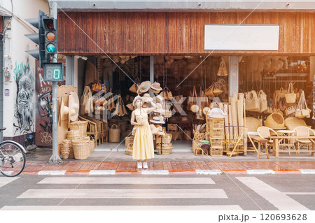 Young asian woman traveler in dress with hat traveling to wicker shop on Chang Moi Kao Road, Tourist visit at the old city in Chang Mai, Thailand. Asia Travel, Vacation and summer holiday concept Young asian woman traveler in dress with hat traveling to wicker shop on Chang Moi Kao Road, Tourist visit at the old city in Chang Mai, Thailand. Asia Travel, Vacation and summer holiday concept 120693628