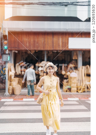 Young asian woman traveler in dress with hat traveling to wicker shop on Chang Moi Kao Road, Tourist visit at the old city in Chang Mai, Thailand. Asia Travel, Vacation and summer holiday concept 120693630