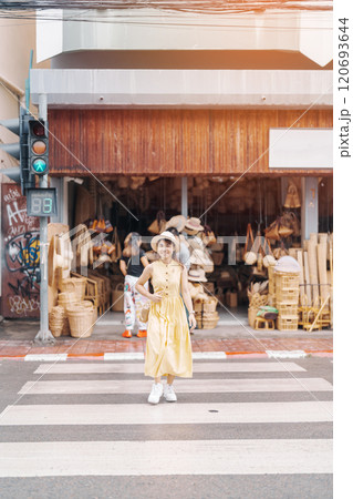 Young asian woman traveler in dress with hat traveling to wicker shop on Chang Moi Kao Road, Tourist visit at the old city in Chang Mai, Thailand. Asia Travel, Vacation and summer holiday concept Young asian woman traveler in dress with hat traveling to wicker shop on Chang Moi Kao Road, Tourist visit at the old city in Chang Mai, Thailand. Asia Travel, Vacation and summer holiday concept 120693644