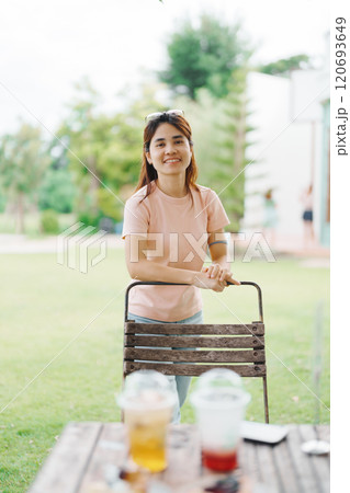 Happy woman with Dessert in cafe, young Asian girl smiling during eating cake and drinking ice beverage at home 120693649