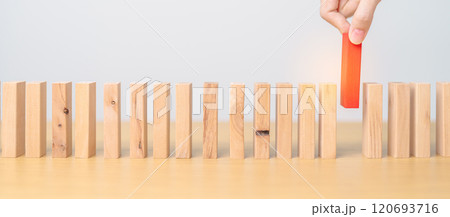 hand placing or pulling Red domino wooden block on table. Business planning, Risk Management, Solution, leader, strategy, different, Hiring, Human Resource and Unique Concepts hand placing or pulling Red domino wooden block on table. Business planning, Risk Management, Solution, leader, strategy, different, Hiring, Human Resource and Unique Concepts 120693716