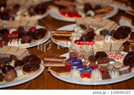 A Delicious Assortment of Fine Chocolates and Sweets Beautifully Arranged on Plates A Delicious Assortment of Fine Chocolates and Sweets Beautifully Arranged on Plates 120694107