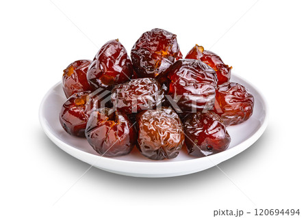 Pile of sweet pitted chinese jujube fruit preserved in syrup in white ceramic dish. Pile of sweet pitted chinese jujube fruit preserved in syrup in white ceramic dish. 120694494