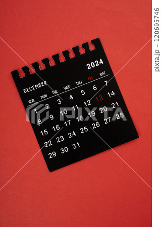 Black calendar December 2024 focus on friday 13, On red background. 120695746