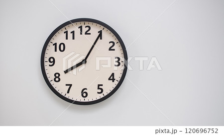 Classic Black-Edged Clock on White Background at 20.05/08.05 - Perfect for Time Management and Text Space 120696752