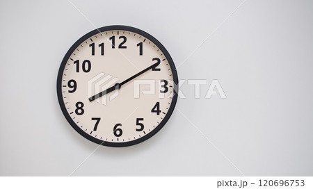Classic Black-Edged Clock on White Background at 20.10/08.10 - Perfect for Time Management and Text Space 120696753
