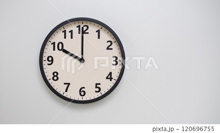 Classic Black-Edged Clock on White Background at 22.00/10.00 - Perfect for Time Management and Text Space 120696755