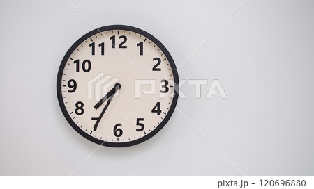 Classic Black-Edged Clock on White Background at 19.35/07.35 - Perfect for Time Management and Text Space 120696880
