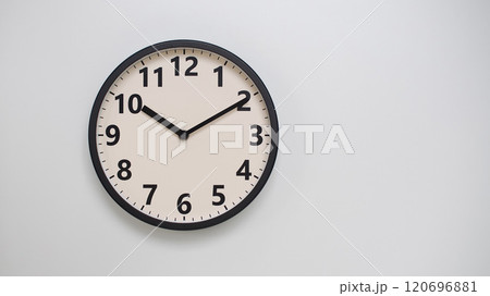 Classic Black-Edged Clock on White Background at 22.10/10.10 - Perfect for Time Management and Text Space Classic Black-Edged Clock on White Background at 22.10/10.10 - Perfect for Time Management and Text Space 120696881