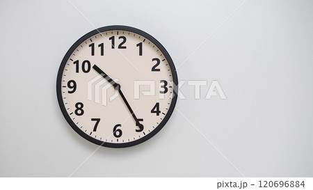 Classic Black-Edged Clock on White Background at 10.25/22.25 - Perfect for Time Management and Text Space 120696884