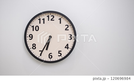 Classic Black-Edged Clock on White Background at 18.35/06.35 - Perfect for Time Management and Text Space 120696984
