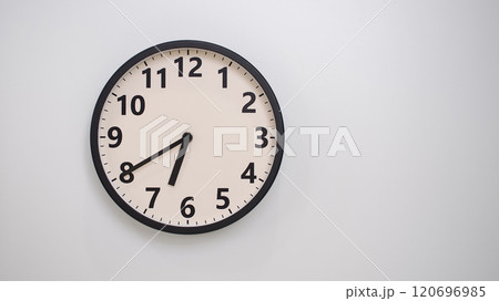 Classic Black-Edged Clock on White Background at 18.40/06.40 - Perfect for Time Management and Text Space 120696985