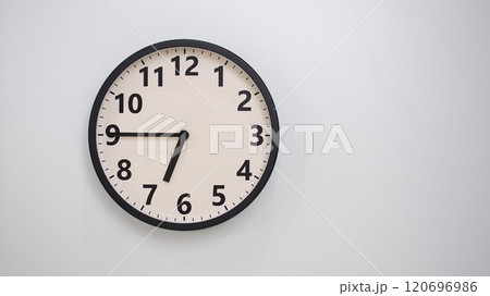 Classic Black-Edged Clock on White Background at 18.45/06.45 - Perfect for Time Management and Text Space 120696986