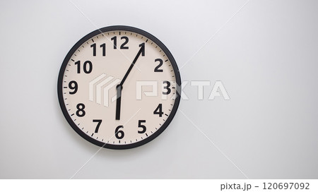 Classic Black-Edged Clock on White Background at 18.05/06.05 - Perfect for Time Management and Text Space 120697092
