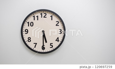 Classic Black-Edged Clock on White Background at 17.30/05.30 - Perfect for Time Management and Text Space 120697259