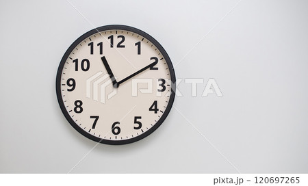 Classic Black-Edged Clock on White Background at 23.10/11.10 - Perfect for Time Management and Text Space 120697265