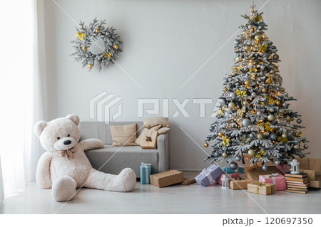 White snow Christmas tree with gifts, toys, garlands in the interior for the new year 120697350