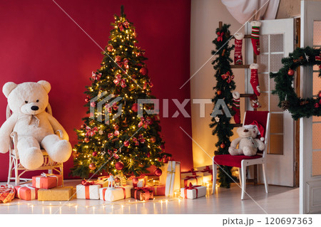 Christmas tree with red gifts garlands in the interior new year 120697363
