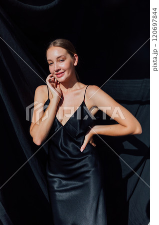 Beautiful fashion woman in black evening silk dress 120697844