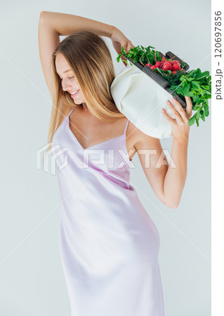 Beautiful woman with a bag of green vegetables for a diet Beautiful woman with a bag of green vegetables for a diet 120697856