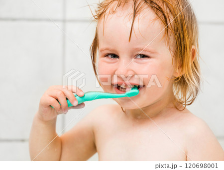 Dental hygiene. Cute baby brushing teeth in bathroom 120698001