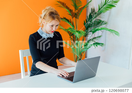 Portrait of happy millennial Caucasian businesswoman work on laptop online at home office. Portrait of happy millennial Caucasian businesswoman work on laptop online at home office. 120698077