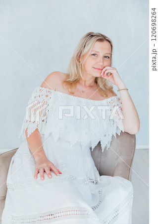 Beautiful blonde woman in summer white wedding dress Beautiful blonde woman in summer white wedding dress 120698264