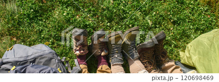 Website banner with high angle shot of unrecognizable camper legs sticking out of tent Website banner with high angle shot of unrecognizable camper legs sticking out of tent 120698469