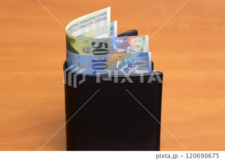 Swiss franc in the black wallet 120698675