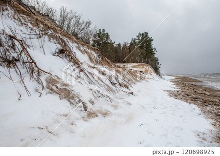 Baltic Sea wild beach is snowy in winter and there are big waves Baltic Sea wild beach is snowy in winter and there are big waves 120698925